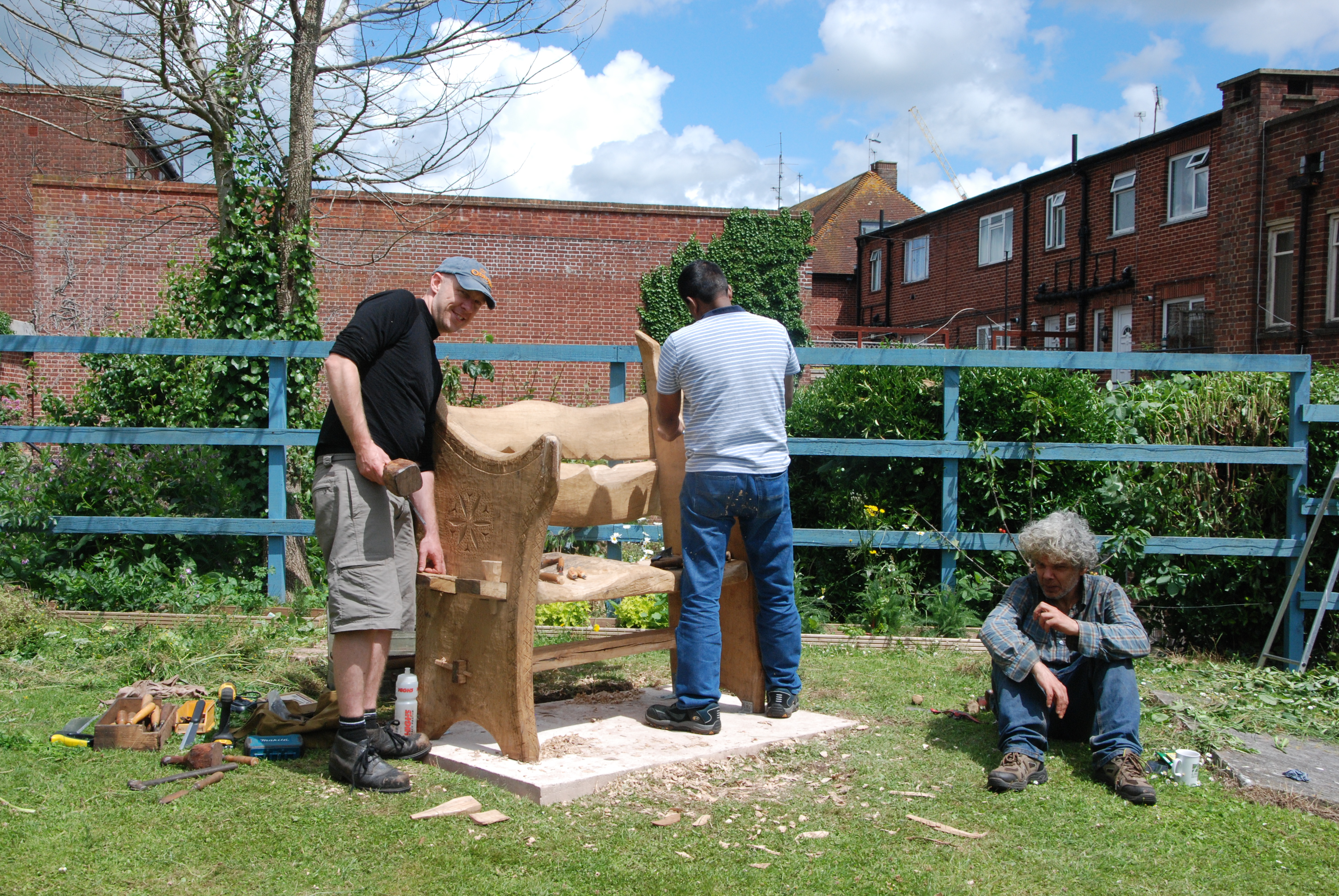 volunteers working on new benches in the grounds of st sidwells