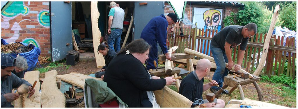 volunteers hard at work creating benches to go in the garden.