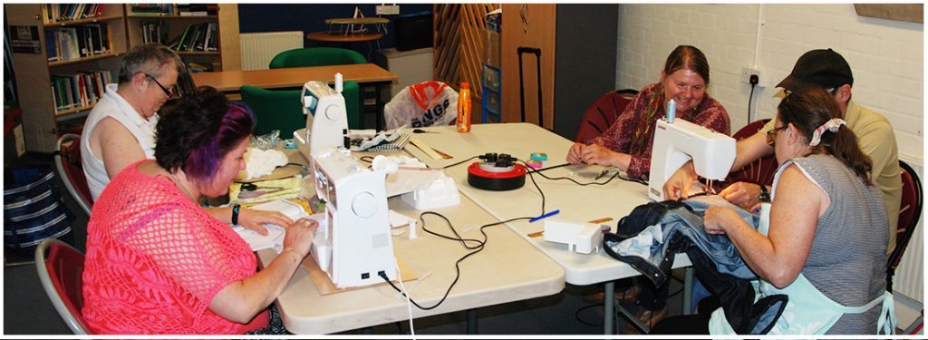 a busy group of women sewing and crafting