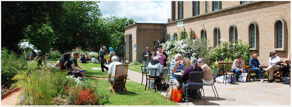 many people at an open day, enjoying the garden